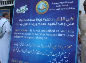 The sign reads: "Dear visitor: it is not prescribed to visit this library as a kind of woship, because there is no evidence to support doing so."