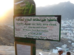 A sign reads: "Kindly keep our hold area clean." The sign is severely defaced, with grafitti all over it.
