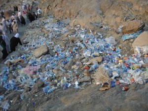 Discarded bottles, cans, and other garbage lies strewn on the mountain