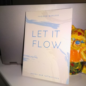 Winnie the Pooh behind a printed copy of the book "Let it Flow"
